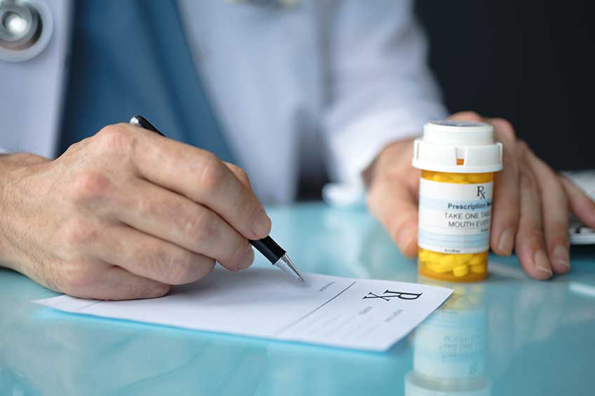 Pharmacist writing a prescription